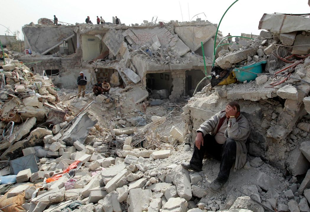 A man at a site recently hit by what activists said was a Scud missile in Aleppo’s Ard al-Hamra neighborhood, February 23, 2013. REUTERS/Muzaffar Salman